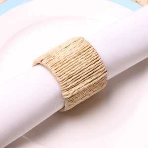Handcrafted natural grass woven napkin ring on a white plate for elegant table settings