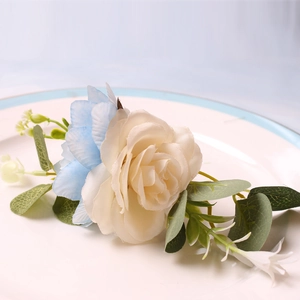 Detailed view of handmade dual-tone flower napkin ring with rose and eucalyptus leaves