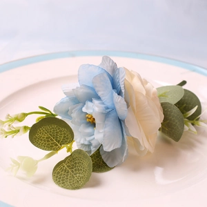 Detail of DIY woven bicolor flowers napkin ring on a white ceramic dinner plate