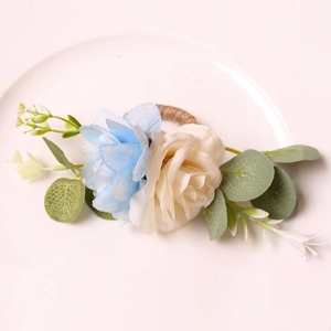 Detail of blue and beige woven floral napkin rings on a white ceramic dinner plate