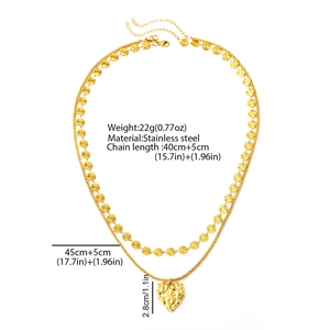 Detail of gold double-layer stainless steel necklace featuring a textured heart pendant