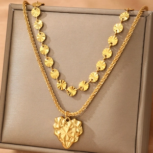 Vintage double layer gold heart pendant necklace on a jewelry box display