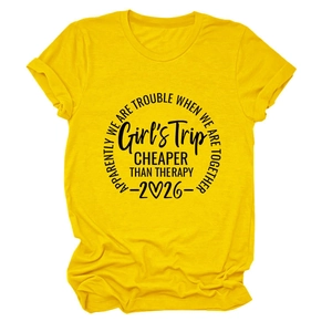 Detail of knit fabric and Girls Trip 2026 black graphic print on yellow T-shirt