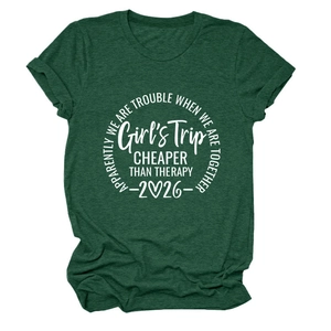 Detail of heather green Girl's Trip T-shirt featuring white screen-printed graphic text