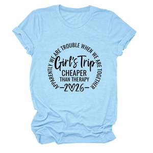 Detail of Girl's Trip slogan and 2026 print on casual light blue cotton t-shirt