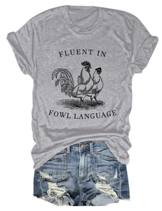Flat lay of grey 'Fluent in Fowl Language' rooster t-shirt with ripped denim shorts