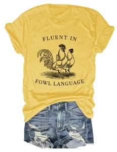 Detail of ginger cotton t-shirt with rooster print and Fluent in Fowl Language slogan