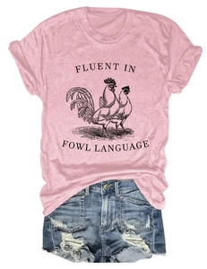 Flat lay of pink t-shirt with fowl language graphic paired with blue distressed denim shorts