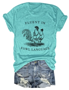 Detailed flat lay of a turquoise rooster graphic tee and ripped denim shorts for summer
