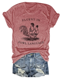 Flat lay of brick red T-shirt with fowl language print and distressed denim shorts