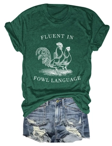 Flat lay of green fowl language t-shirt paired with ripped denim shorts on white background