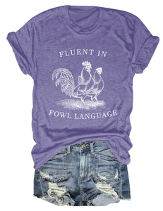 Flat lay of purple fowl language t-shirt paired with distressed blue denim shorts