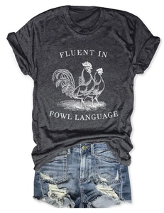 Detailed flat lay of charcoal grey t-shirt with Fluent in Fowl Language print and denim