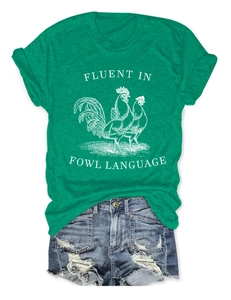 Flat lay of green Fowl Language t-shirt paired with distressed denim shorts