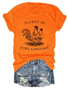 Detail of orange T-shirt with fowl language print and blue ripped denim shorts