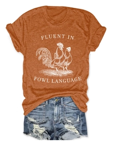 Rust orange T-shirt with fowl graphic and distressed denim shorts flat lay display