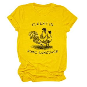 Detail of creative fowl language slogan and rooster graphic on bright yellow cotton t-shirt