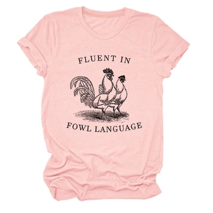 Detail of light pink t-shirt with rooster print and Fluent In Fowl Language slogan