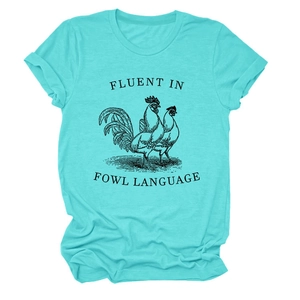 Close-up of funny Fluent in Fowl Language slogan and chicken illustration on blue t-shirt