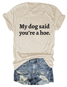 Flat lay of beige T-shirt with humorous slogan and distressed denim shorts outfit
