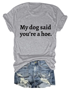 Flat lay of gray cotton T-shirt with My dog said you're a hoe slogan and denim shorts