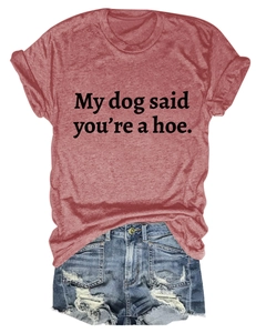 Flat lay of casual brick red t-shirt with My Dog Said text and blue ripped denim shorts