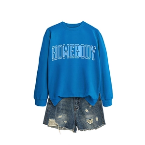 Royal blue Homebody sweatshirt paired with distressed denim shorts on a plain white background