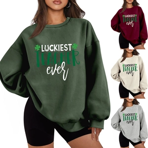 Detail view of Luckiest Teacher Ever sweatshirts in green, red, cream, and grey colors