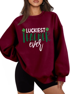 Detail of burgundy thick fleece sweatshirt with Luckiest Teacher Ever text and clover print