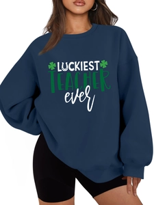 Detail of navy blue Luckiest Teacher Ever sweatshirt with green clover print design