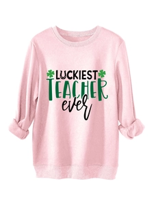 Detail of light pink sweatshirt featuring Luckiest Teacher Ever print and shamrock graphics