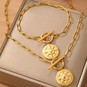 Gold paperclip chain jewelry set with eight-point star pendant and toggle clasp