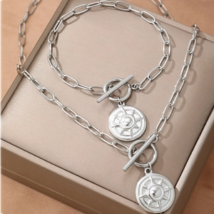 Silver punk chain jewelry set with starburst OT buckle and engraved disk pendant