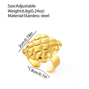 Detail of golden stainless steel ring featuring a quilted square top with glossy finish