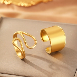 Minimalist gold ring set with wide smooth band and twisted rope style open rings