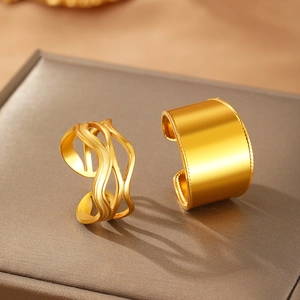 Detail of 18k gold plated stainless steel double layer textured open rings on leather display