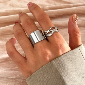 Detail of silver dual-layer threaded rings on silk background with polished finish