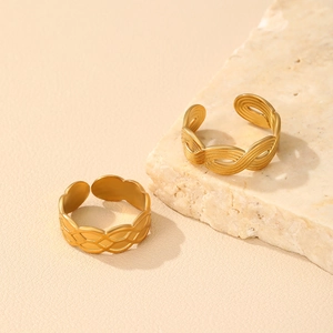 Detailed close-up of matte gold adjustable open rings with woven textures and mesh patterns