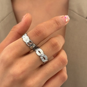 Minimalist silver stackable rings featuring geometric hollow and spiral infinity textures