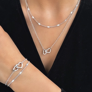 Double-layered stainless steel necklace and bracelet set with interlocking silver hearts