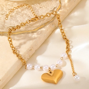 Handmade baroque freshwater pearl bracelet with golden heart pendant on silk fabric