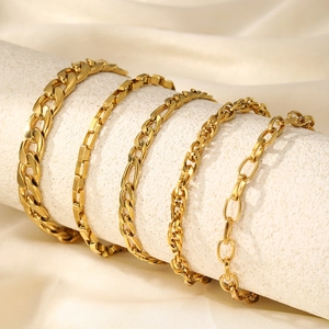 Set of five elegant gold-plated stainless steel chain bracelets for women on a display