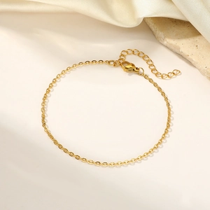 Elegant gold layered link bracelet with lobster clasp on minimalist stone background