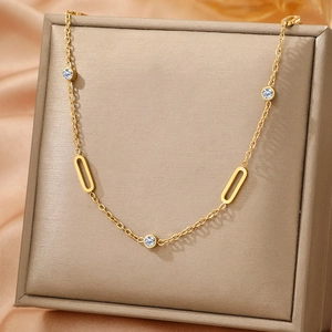 Minimalist gold stainless steel necklace with round cubic zirconia and oval metal charms