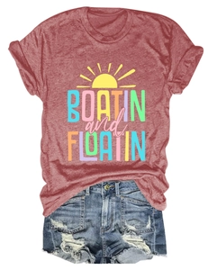 Flat lay of a red BOATIN and FLOATIN graphic t-shirt and distressed denim shorts