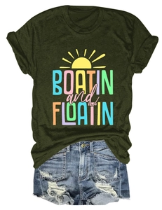 Close-up of Boatin and Floatin print on dark green cotton t-shirt with denim shorts
