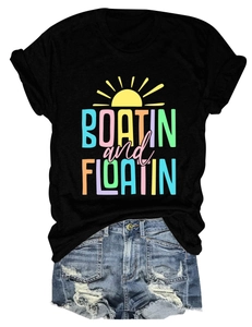 Flat lay of black Boatin and Floatin print t-shirt and distressed blue denim shorts