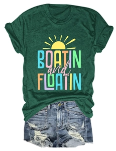 Flat lay of green Boatin and Floatin short sleeve tee with distressed denim shorts
