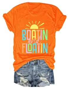 Flat lay of orange cotton T-shirt with Boatin and Floatin print and ripped denim shorts