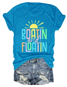 Flat lay view of a teal cotton t-shirt with sun graphic and ripped denim shorts